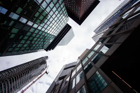 skyward — glass towers seen from the street, looking up